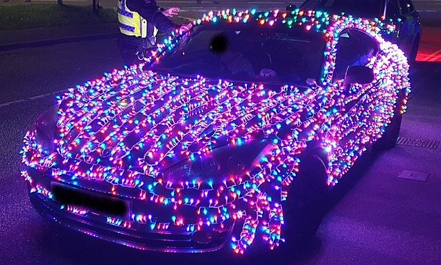 Motorist who covered his car with Christmas lights is pulled over by police - as officers warn they could 'end up on Santa's naughty list'
