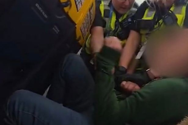 Moment Ryanair passenger clashes with cops after 'refusing to sit down'