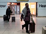 British political commentator is greeted by his family after flying home from the US after being held by ICE for two weeks