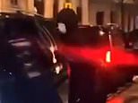 Moment hooded gang 'rob revellers in taxi' as crowd stands and films it on their phones in central London