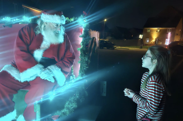 Santa surprises schoolgirl with early Christmas as dad has just days to live
