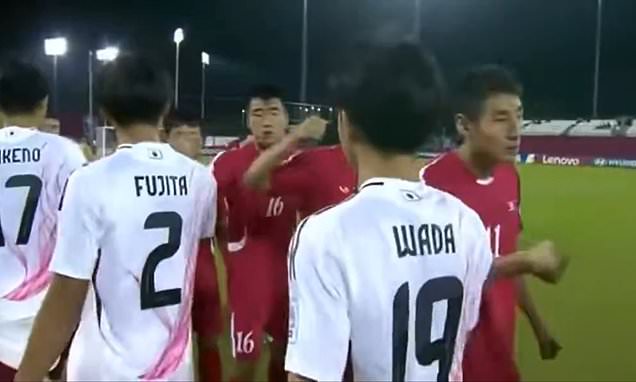 The bizarre moment North Korean footballers PUNCH their Japanese rivals instead of traditional pre-match handshakes: FIFA asked to intervene